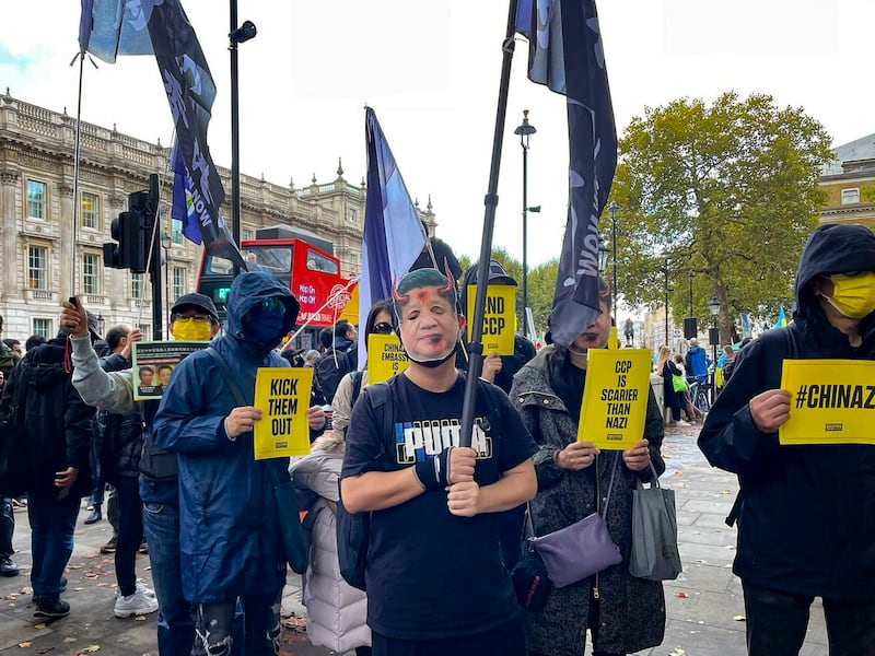 A protester in London wears a devil mask of Chinese leader Xi Jinping's face in this Oct. 23, 2022, photo. (Credit: RFA London Correspondent Amelia Loi)