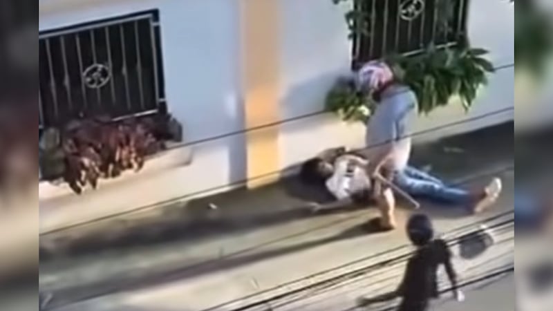 This image made from video shows a Cambodian migrant worker laying on the ground after an attack by a group of Thais.