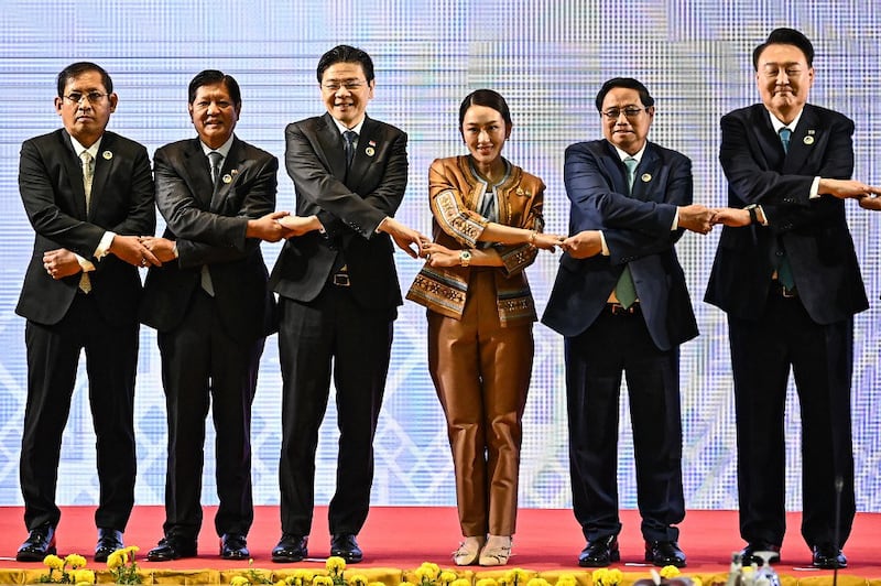 From left, Myanmar's Permanent Secretary of Foreign Affairs Aung Kyaw Moe, Philippines' President Ferdinand Marcos Jr, Singapore's Prime Minister Lawrence Wong, Thailand's Prime Minister Paetongtarn Shinawatra, Vietnam's Prime Minister Pham Minh Chinh, and South Korea's President Yoon Suk Yeol pose for a group photo at the 25th ASEAN-South Korea Summit during the 44th and 45th Association of Southeast Asian Nations (ASEAN) Summits in Vientiane, Oct. 10, 2024. (Nhac Nguyen/AFP)