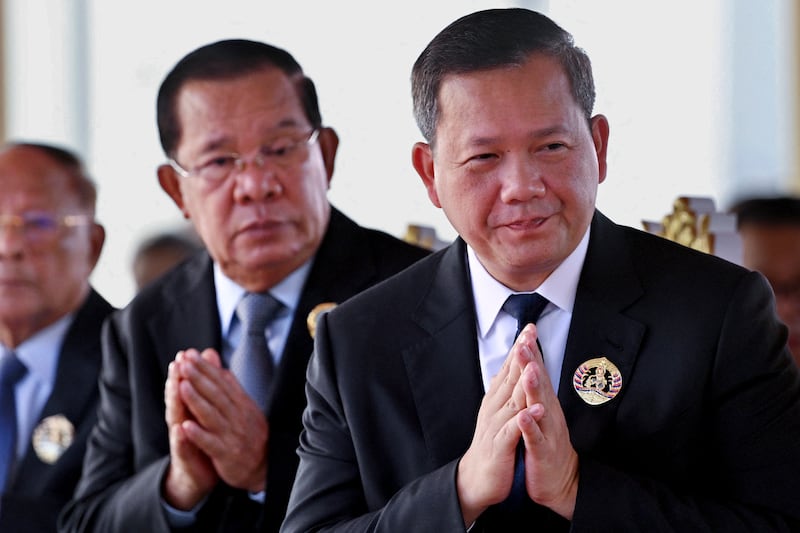President of the Senate Hun Sen, left, and Cambodia's Prime Minister Hun Manet, right, during a ceremony marking the 74th founding anniversary of the Cambodian People's Party (CPP) in Phnom Penh on June 28, 2025.
