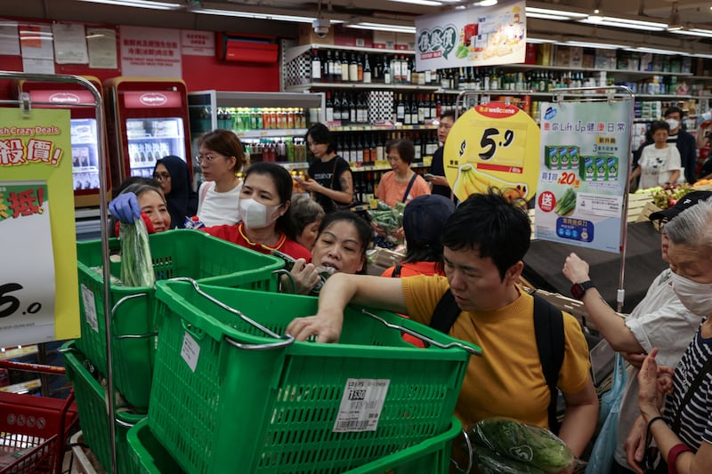 Residents stock up on supplies at a supermarket to prepare for the approaching Typhoon Ragasa, in Hong Kong on Sept. 22, 2025. REUTERS/Tyrone Siu